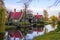 Beautiful view of a small Zaan village , with traditionally built houses of green painted wood and red roof tiles .