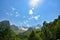 A beautiful view of the snow-capped mountain peaks of the Caucasus Mountains. White clouds against the blue blue sky