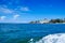 Beautiful view of some buildings in the horizont with a gorgeos blue water in San Andres Island during a sunny day in