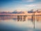 Beautiful view of Songkhla Lake reflecting the pilings and clouds at sunset. Thailand.