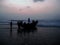 Beautiful view of before sunrise dark on seascape and silhouette of fish farmers and boat.
