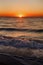 Beautiful view of sunrise in sea. Close Up of waves and beach at sea and colorful sky during sun rise, atmospheric moment. Sunset