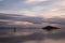 Beautiful view of sunset at Trasimeno lake Umbria, Italy, with clouds and islands reflections on water