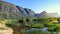 Beautiful view of swamp with hippos and a mountain range