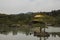 Beautiful view of a temple surrounded by water and a forest in Kinkakuji, Kyoto, Japan