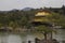 Beautiful view of a temple surrounded by water and a forest in Kinkakuji, Kyoto, Japan