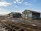 Beautiful view of a three small old wood houses on the side of old rusty railway road