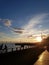 Beautiful view to the sunset over the Neva. Against the cable-stayed bridge. Embankment. on the railing sits a couple in love