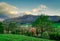 Beautiful view from top of hill. Village in valley. Tree in early spring with blue sky and white clouds. Sunshine to rock mountain