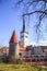 Beautiful view of the tower Oleviste Churchand the Fortress wall in Tallinn, Estonia