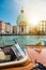 Beautiful view of traditional taxi boat on famous Canal Grande with Basilica in golden sunset light in Venice, Italy