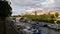 Beautiful view of tranquil Canal Saint-Martin with promenade, trees, docking boats and modern opera house Opera Bastille.