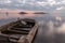 Beautiful view of Trasimeno lake Umbria at dusk, with a little, old boat partially filled by water, perfectly still