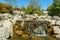 Beautiful view of Triple waterfall in Japanese garden. Public landscape park of Krasnodar or Galitsky Park