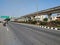 Beautiful view of Tumkur or Nelamangala 8 Lane Road with flyover, metro pillar and metro stop with limited traffic jam on road