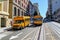 Beautiful view of two yellow school busses on street of San Francisco. Beautiful nature landscape backgrounds.