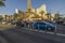 Beautiful view of vehicles in traffic on Strip passing by beautiful hotels on blue sky background. Las Vegas,  Nevada,