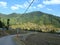 A beautiful view of a village a road electric pools wire and forests