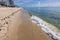 Beautiful view of waves of Atlantic Ocean rolling onto sandy beach of Miami Beach.