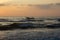 Beautiful view of the waves and the fishing boats along the Marina beach during the sunrise, Chennai, India. Fishermen venturing