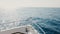 Beautiful view of white cruise yacht boat nose sailing on waves into sunny bright open sea horizon on clear summer day.