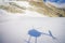 Beautiful view at white mountains covered with snow, with a helicopter shadow in the snow, in South Westland`s Southern