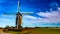 Beautiful view of a windmill next a field on a wonderful sunny day