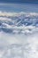 Beautiful view from window of plane flying over clouds. White clouds moving above the ground.