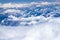 Beautiful view from window of plane flying over clouds. White clouds moving above the ground.