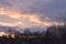 Beautiful view of the winter sunset with silhouettes of forest trees and an old church