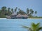 Beautiful view of wooden overwater villas near a white sand tropical beach.