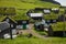 Beautiful village of Mykines with colorful houses with grass on the roofs, Mykines island, Faroe Islands, Europe