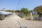 Beautiful village parking cars view on cloudless blue sky background.