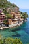 Beautiful villas on the shore of Portofino with clear green water of the Mediterranean sea, Portofino, Italy