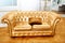 Beautiful vintage gold sofa next to wall (retro-style illustration)