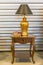 Beautiful vintage golden standing table lamp light bulb on antique wooden table with the book retro style interior for home and