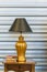 Beautiful vintage golden standing table lamp light bulb on antique wooden table with the book retro style interior for home and