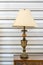 Beautiful vintage metal standing table lamp light bulb on antique wooden table retro style interior for home and living classic