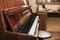 A beautiful vintage piano with an open lid is at home to work on a piano. The piano keys are ready to play on them