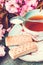 Beautiful, vintage teacup with Japanese cherry tree blossom and Scottish shortbread, close up