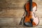 Beautiful violin and bow on table, top view. Space for text