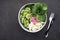 Beautiful vitamin healthy vegetable salad. Cucumbers, cabbage, daikon, lettuce, young peas in the same bowl. Top view.