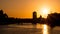 Beautiful vivid sunset over River Liffey in Dublin, Ireland with sun directly behind the Spire and silhouetted buildings