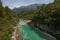 Beautiful vivid turquoise river stream rapids, running through canyon a forest. Soca river, Triglav National Park, Julian Alps, Sl