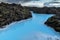 Beautiful volcanic terrain with black volcanic rocks and turquoise water at blue lagoon geothermal spa in Iceland