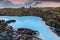 Beautiful volcanic terrain with black volcanic rocks and turquoise water at blue lagoon geothermal spa in Iceland