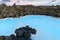 Beautiful volcanic terrain with black volcanic rocks and turquoise water at blue lagoon geothermal spa in Iceland