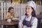 Beautiful waitress smiling at camera in cafeteria