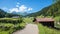 Beautiful walkway Dischma valley near Davos, tourist destination prattigau switzerland. wooden huts in spring landscape