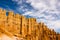 A beautiful wall of amazing limestone hoodoos with various shades of oranges and reds at the stunning Bryce Canyon in all its